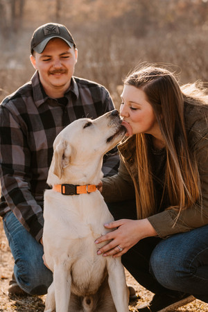 Family picture of Mrs. Johnson, her Husband Dan and their dog Drake.