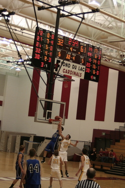 Photo of Ms. DeVries's cousin Danny dunking off an inbounds pass at a basketball game.